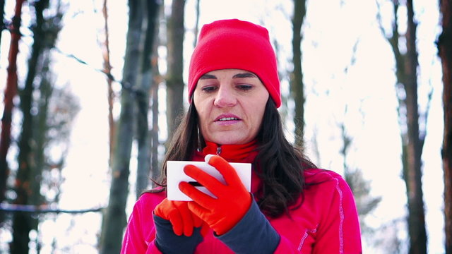 Jogger using cellphone in the forest, steady, slow motion