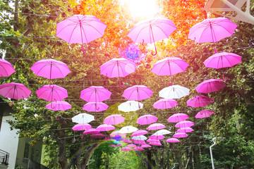 Pink and white umbrellas decorate streets in the resort town Bel