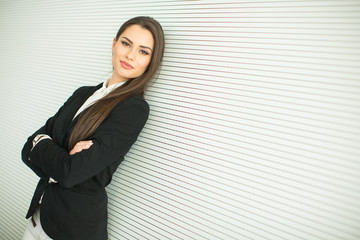 Young bussiness woman by the wall