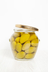 green olive in glass jar isolated on white