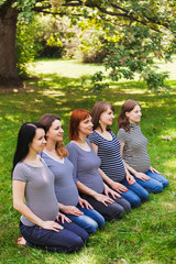 Group of young pregnant women wearing the same clothes and