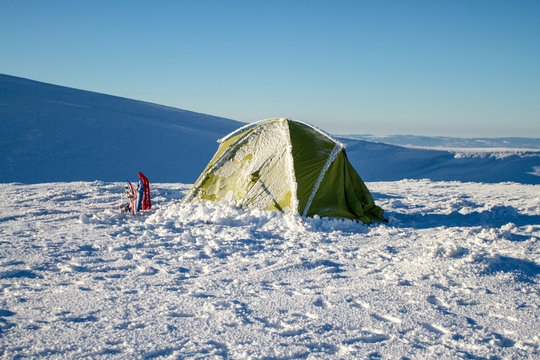 Camping during winter hiking in Carpathian mountains.