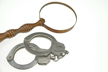 Vintage Magnifying Glass and Handcuffs Isolated