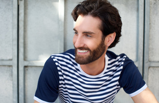 Happy man with beard and striped shirt smiling