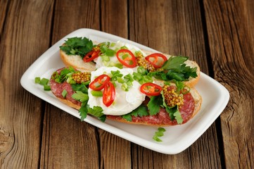 Poached egg sandwiches with chili, scallion and salami