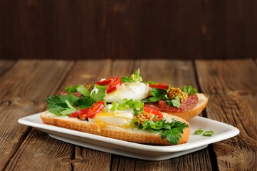 Poached egg sandwiches with chili, scallion and salami