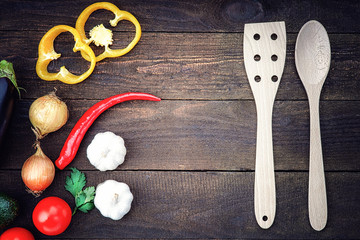 Wooden kitchenware with vegetables on the table