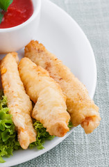 Fried fish fingers with sauce
