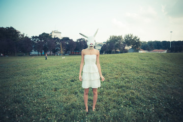 rabbit mask absurd beautiful young woman with white dress