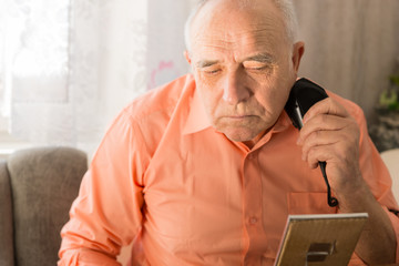 Old Man Shaving Beard with Electric Razor