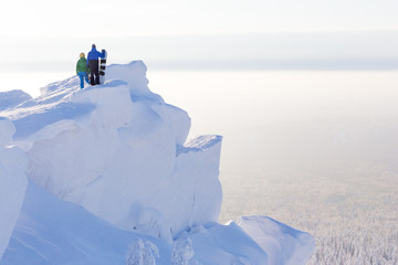 two men with snowboards on the mountain top