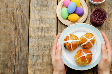 Easter Breakfast. Man holding the plate with the buns with a cro