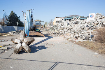Bulldozer crushing the building at construction site