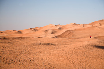 Fototapeta na wymiar Desert dunes, an off-road vehicle alone