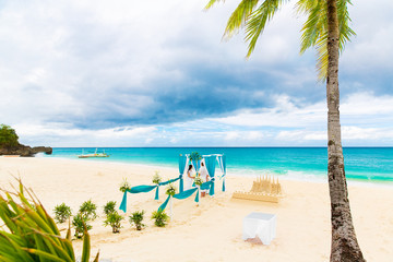 Wedding ceremony on a tropical beach in blue. Wedding arch decor