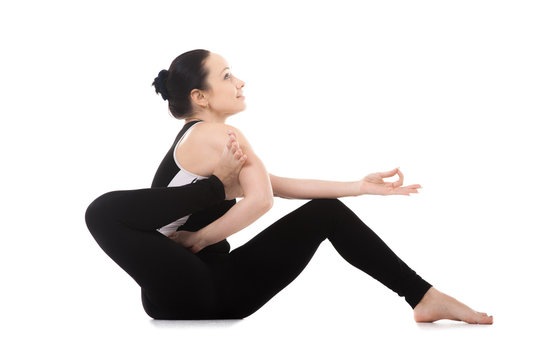 Yogi female doing yoga asana Eka Pada Sirsasana