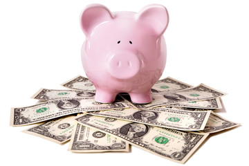 Piggy Bank standing on a pile of US one dollar bills saving money growth concept photo