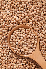 Chickpeas background with large spoone full with seed