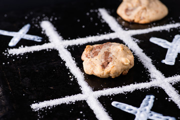 Chocolate chip cookies on noughts and crosses sugar grid
