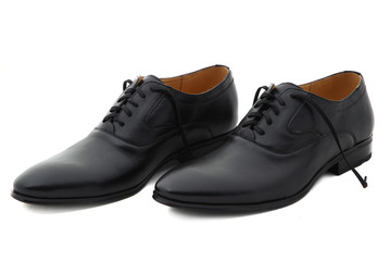 Black patent leather men shoes against white background. Male