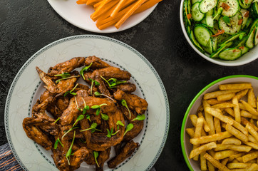 Sports feast - chicken wings, vegetable, french fries, pizza