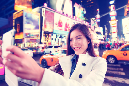 Times Square tourist taking selfie with tablet app
