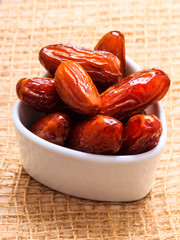 dried dates in bowl on table background