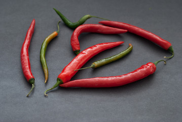 Red and Green Hot Peppers  on Dark Background, selective focus