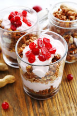 Healthy layered dessert with muesli and berries on table
