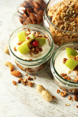 Healthy layered dessert with muesli and fruits on table