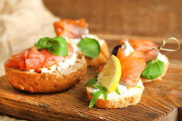 Sandwich with salmon on wooden background