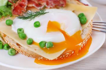 Sandwich with poached egg, cheese and bacon