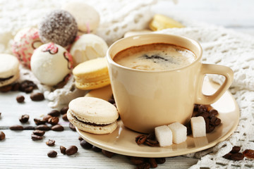 Gentle colorful macaroons and  coffee in mug