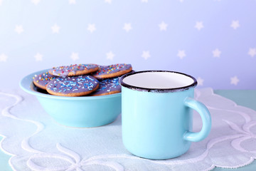 Obraz na płótnie Canvas Bowl of glazed cookies and mug of milk