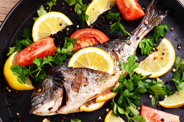 Tasty baked fish on table close-up