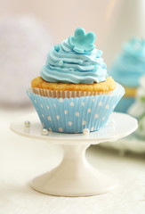 Delicious cupcakes on table on light background