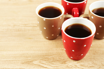 Cups of coffee on wooden table background