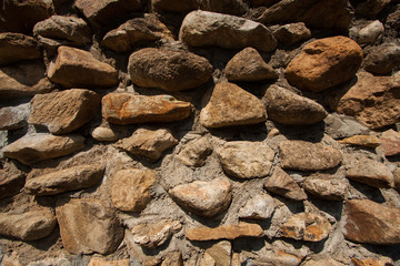 vintage stone wall surface with cement. Closeup old stone wall.