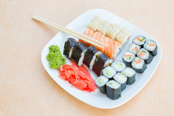 white plate with rolls and chopsticks