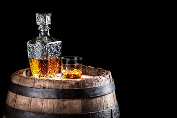 Old oak barrel and a glass of Scotch