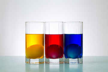 painted Easter eggs in colored liquid