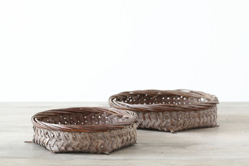Pair flat basket on wooden table