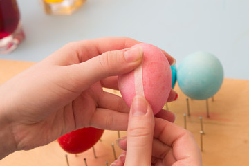 woman glue  white stripe on  pink egg