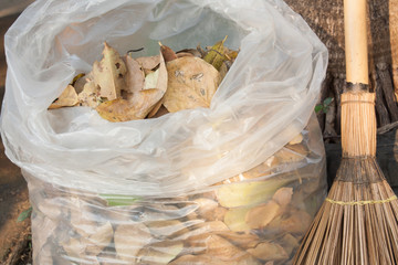 Bag of dry leaves with broom