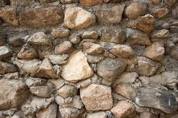 vintage stone wall surface with cement. Closeup old stone wall.