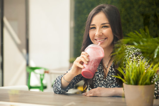 Hispanic Girl Drinking A Smoothie