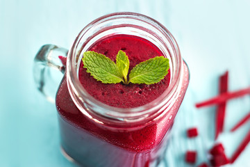 Beetroot smoothie healthy and mint herb on blue wooden