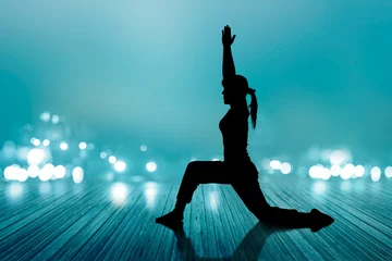 Foto op Plexiglas woman yoga silhouette exercise floor rotten wood, soft and blur © ipopba
