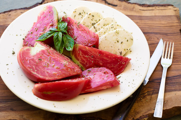 Ripe rose curved tomatoes with mozarella