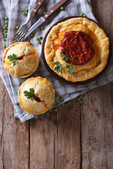 Australian meat pie on a  table. vertical top view